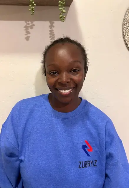Smiling woman wearing blue Zubryiz sweatshirt